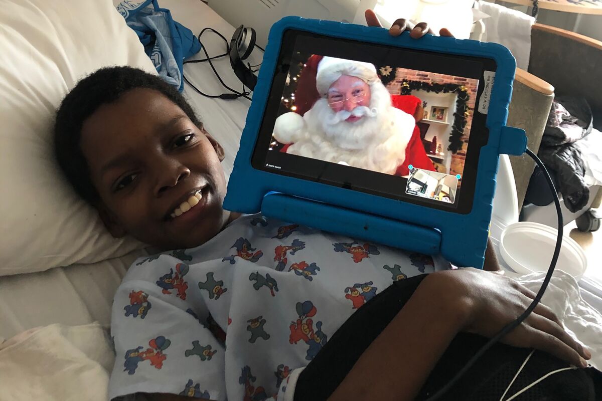Patient Armonte Johnson visits with Santa via Zoom at UCLA's Mattel Children's Hospital on Christmas Eve.
