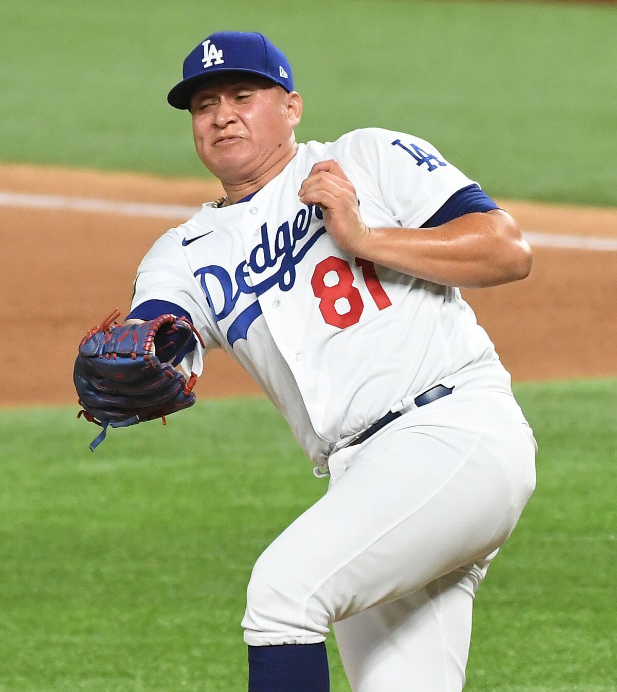 Dodgers reliever Victor González catches a line drive before throwing to second to complete a double play.