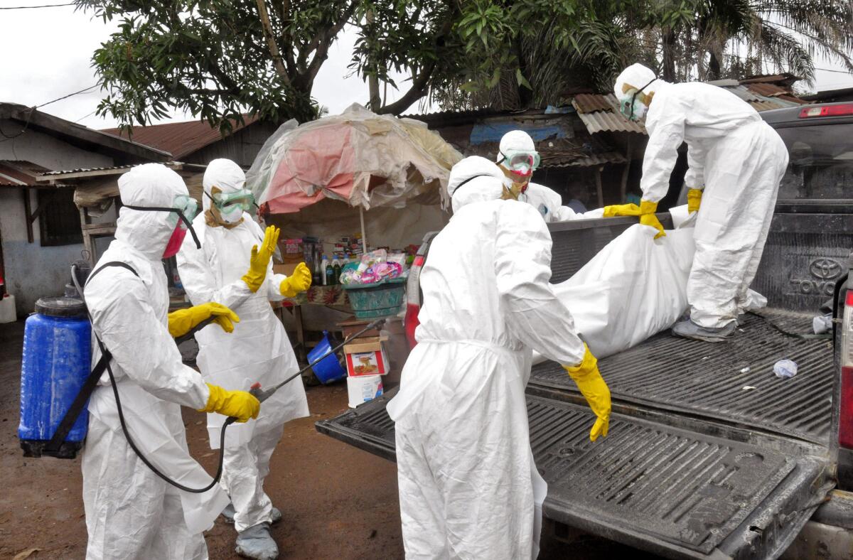 Health workers load the body of a woman they suspect died from the Ebola virus onto a truck in Monrovia, Liberia.