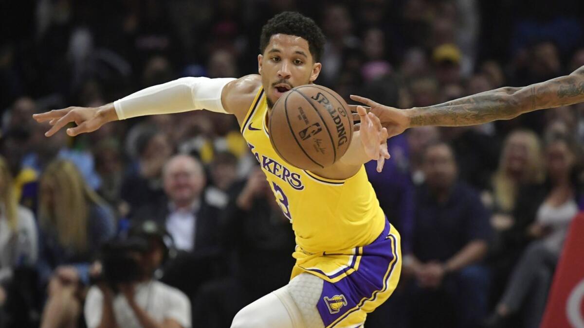 Lakers guard Josh Hart reaches for a loose ball during a game against the Clippers at Staples Center on Jan. 31.