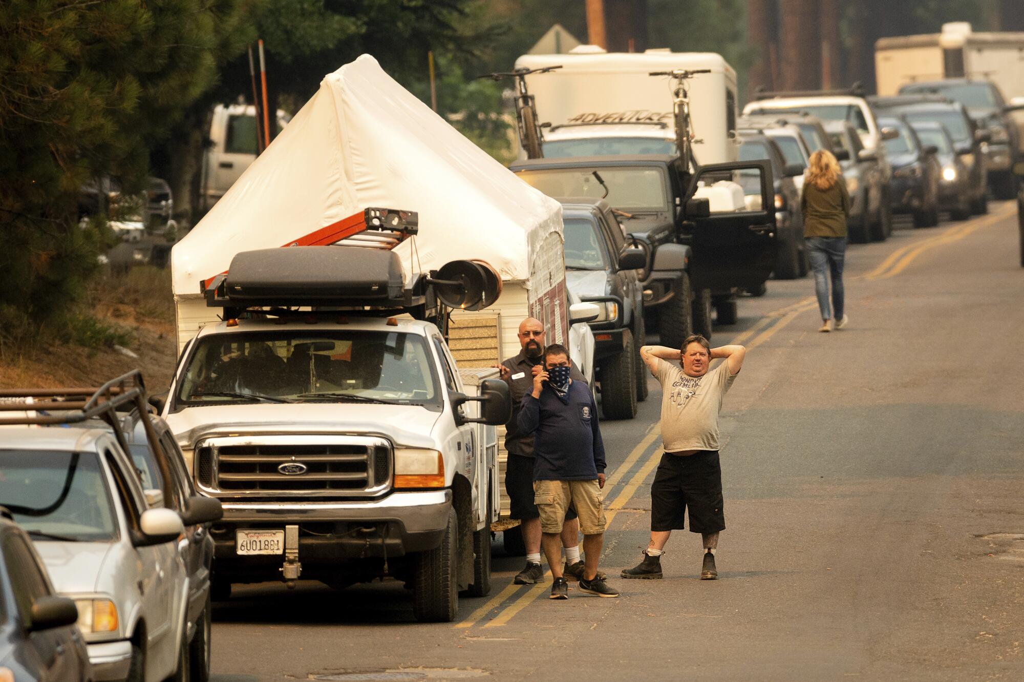 Motorists evacuating from South Lake Tahoe stretch their legs while waiting for traffic to ease.