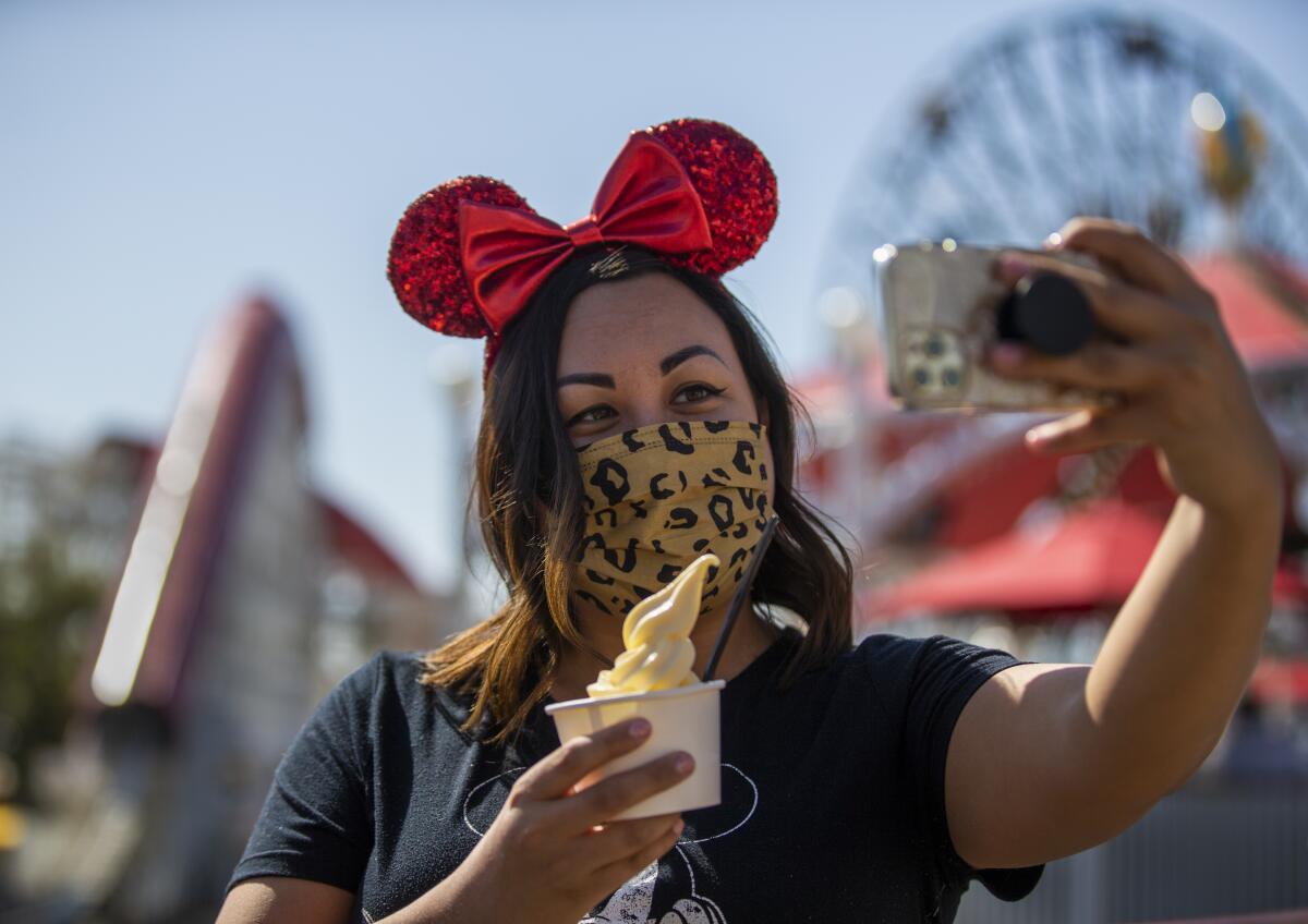 A woman takes a selfie while holding a dessert.