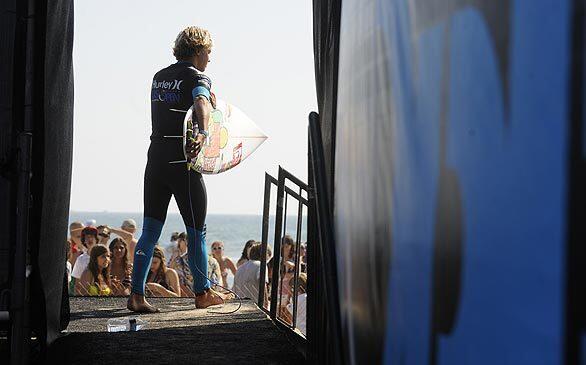 Surfer walks out from backstage