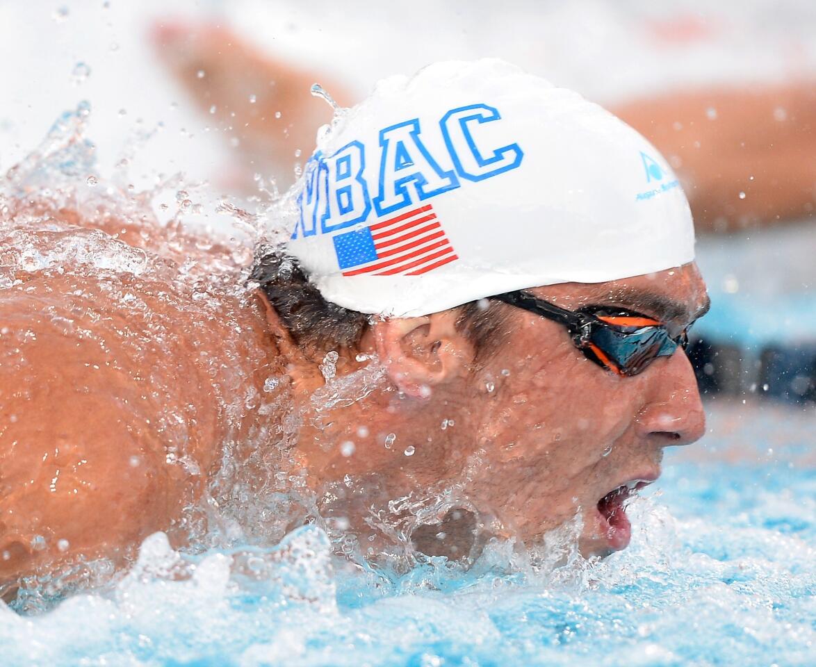 Michael Phelps finished second behind Tom Shields by one one-hundredth of a second at the U.S. national championships on Friday in Irvine.