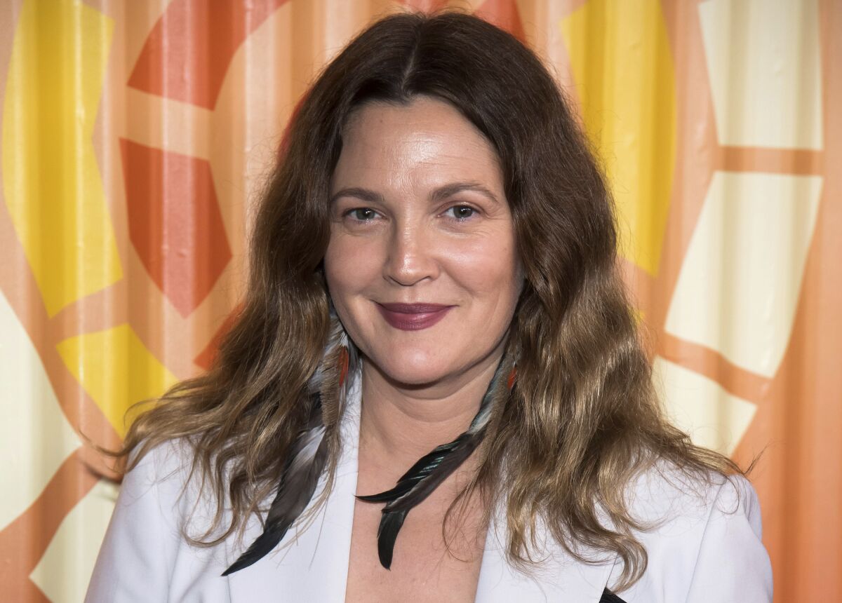 FILE - Drew Barrymore attends The Charlize Theron Africa Outreach Project fundraiser on Nov. 12, 2019, in New York. Barrymore's first show on Monday, Sept. 13, 2020, distributed by the CBS television studio, features former "Charlie's Angels" co-stars Cameron Diaz and Lucy Liu as guests, along with Adam Sandler. Her show, retrofitted for the COVID-19 era, will originate from New York, where she's now living to raise her two daughters. (Photo by Charles Sykes/Invision/AP, file)