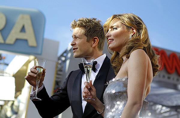 Matt Czuchry of "The Good Wife," the cast of which is nominated for ensemble in a drama series, and Vitalie Taittinger, artistic director of Champagne Taittinger, open the red carpet.