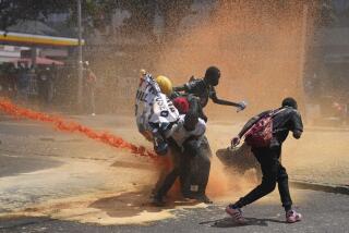 Protesters scatter as Kenya police spray water canon at them during a protest over proposed tax hikes in a finance bill in downtown Nairobi, Kenya Tuesday, June. 25, 2024. (AP Photo/Brian Inganga)
