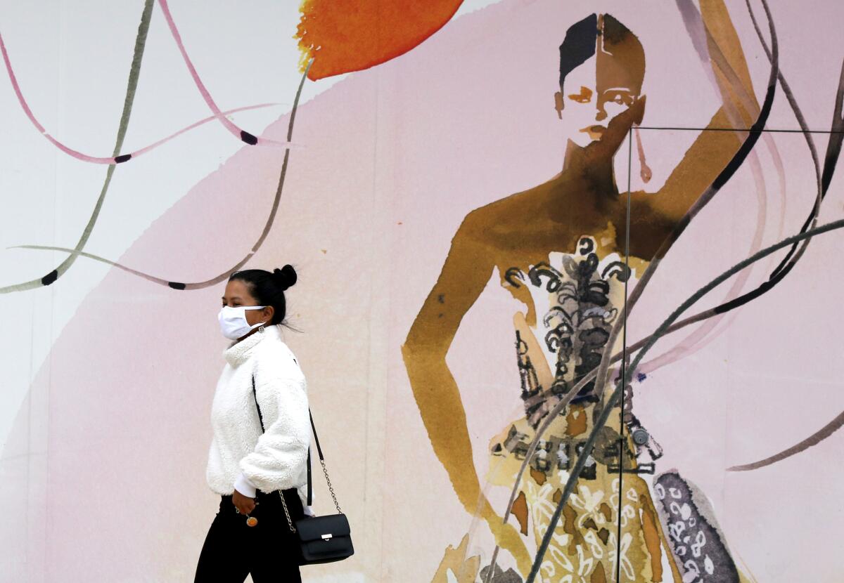 A woman visits South Coast Plaza in Costa Mesa on Friday.