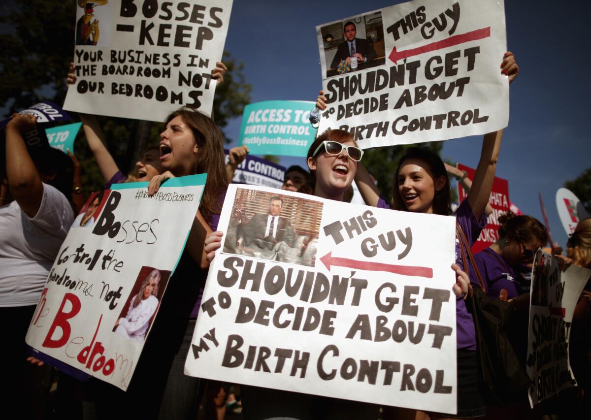 WASHINGTON, DC - JUNE 30: Supporters of employer-paid birth control rally in front of the Supreme Court before the decision in Burwell v. Hobby Lobby Stores was announced June 30, 2014 in Washington, DC. The high court ruled 5-4 that requiring family-owned corporations to pay for insurance coverage for contraception under the Affordable Care Act violated a federal law protecting religious freedom.