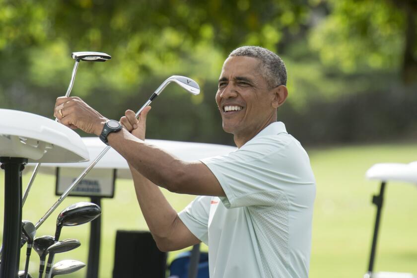 President Obama jokes with reporters as he plays golf with Malaysian Prime Minister Najib Razak at Marine Corps Base Hawaii on Dec. 24.