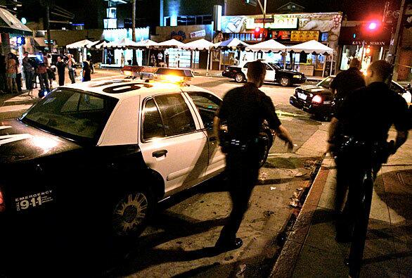 LAPD officers look for evidence where a man was killed and a woman was critically wounded Sunday in a shooting at the Abbot Kinney Street Festival in Venice. The two were shot about 9:20 p.m. in the 1200 block of Abbot Kinney Boulevard.