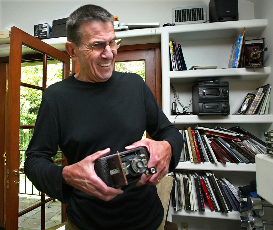 Leonard Nimoy holds his first camera, No. 1 Autographic Kodak Jr., at home in Bel Air in September 2002. He got it at age 12.