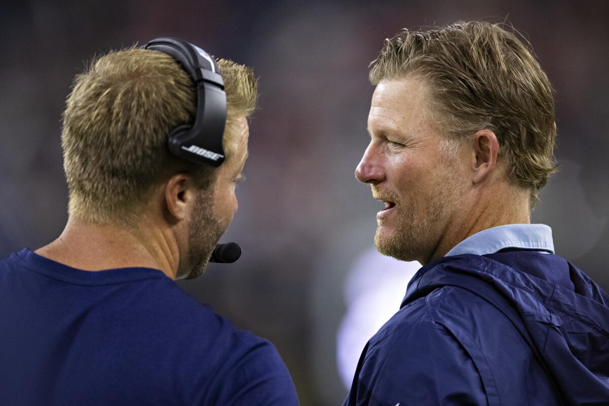 Sean McVay and Les Snead talk on the sideline.