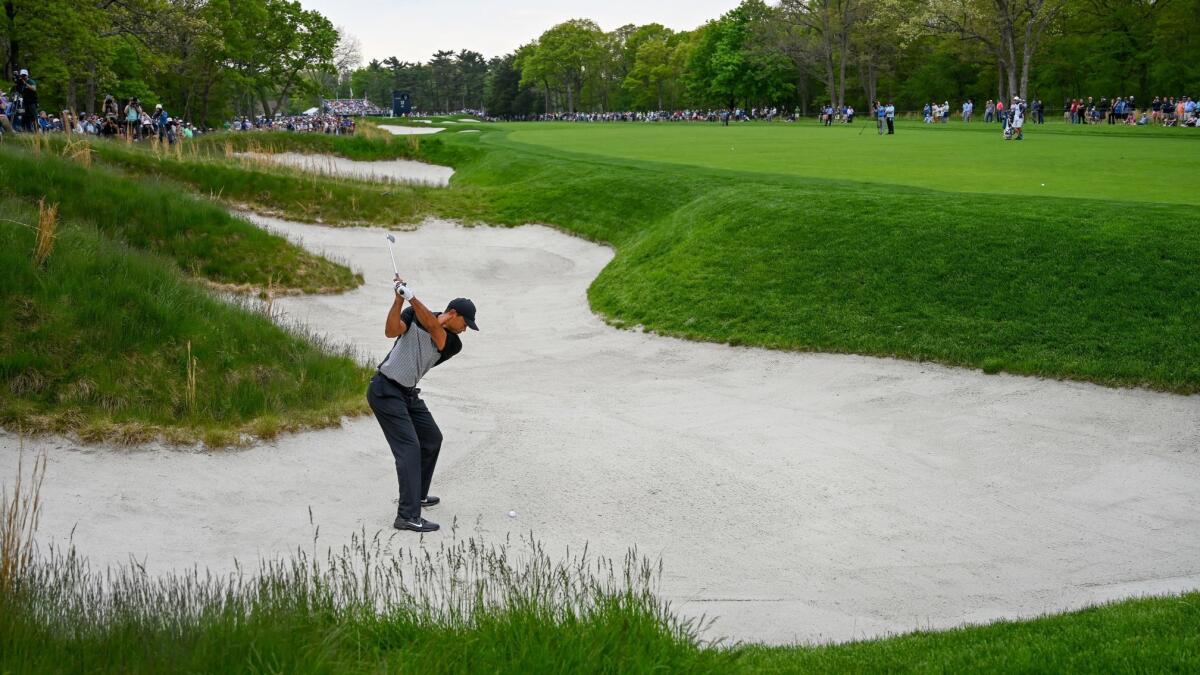 Tiger Woods plays a shot from a bunker on the 13th hole during the second round of the PGA Championship.