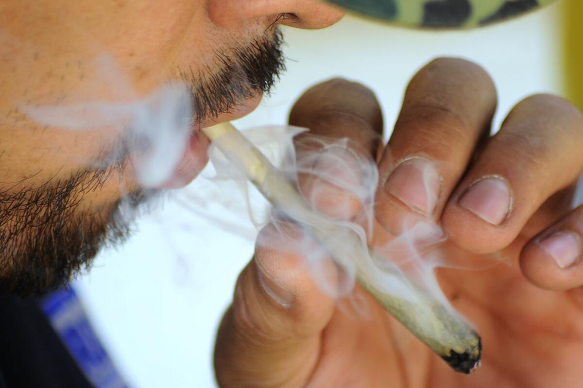 An activist smokes marijuana at a protest encampment outside Mexico’s Senate building.