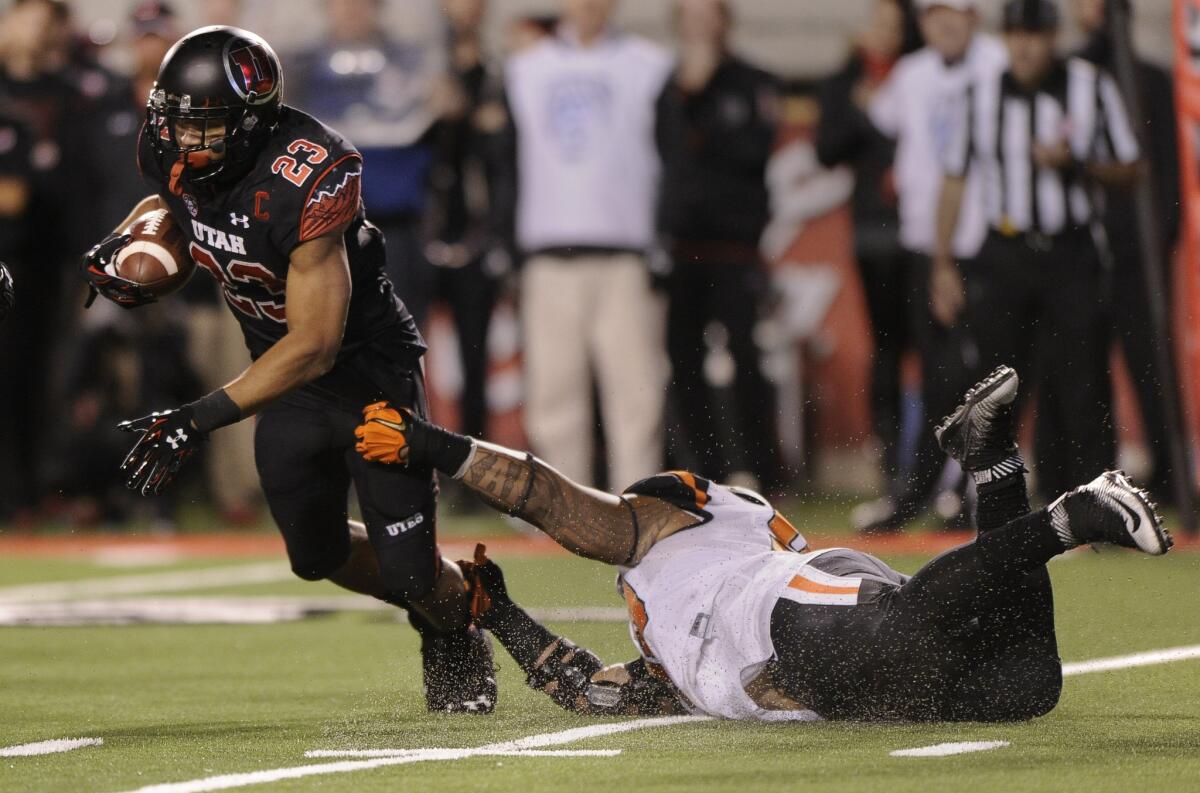 Utah running back Devontae Booker breaks free from Kyle Peko of Oregon State during the third quarter of a game at Rice-Eccles Stadium on Oct. 31.