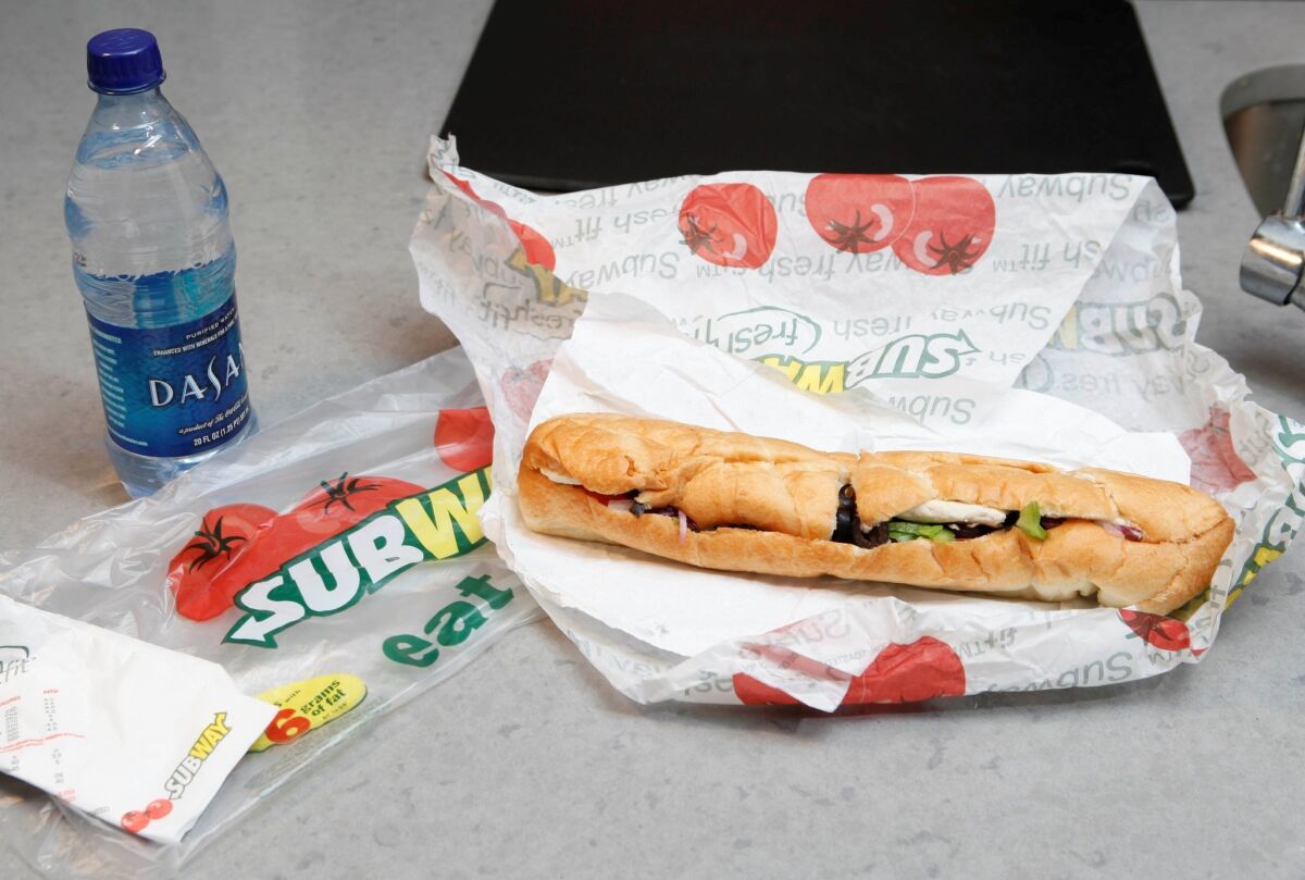 A Subway executive said that an ingredient used in the production of yoga mats would be removed from all of its bread in a week. Above, a 2009 file photo shows a Subway foot-long sandwich.