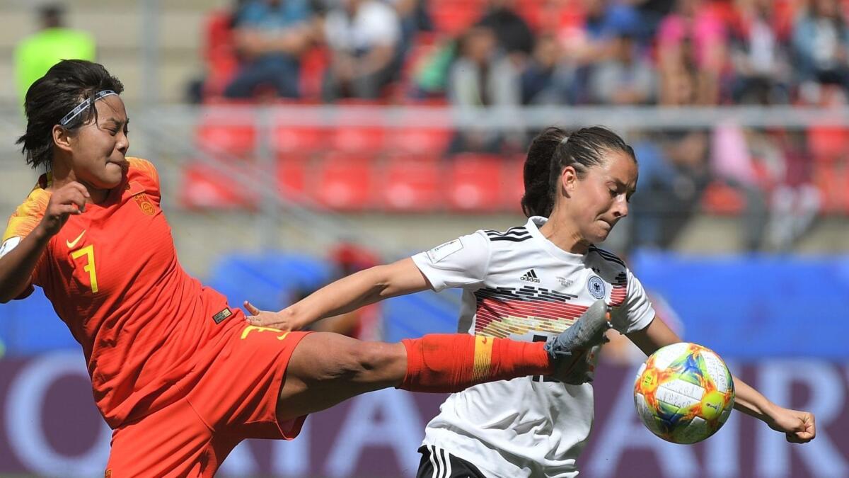 China forward Shuang Wang vies for the ball with Germany midfielder Sara Dabritz during a group-play game at the Women's World Cup on Saturday.