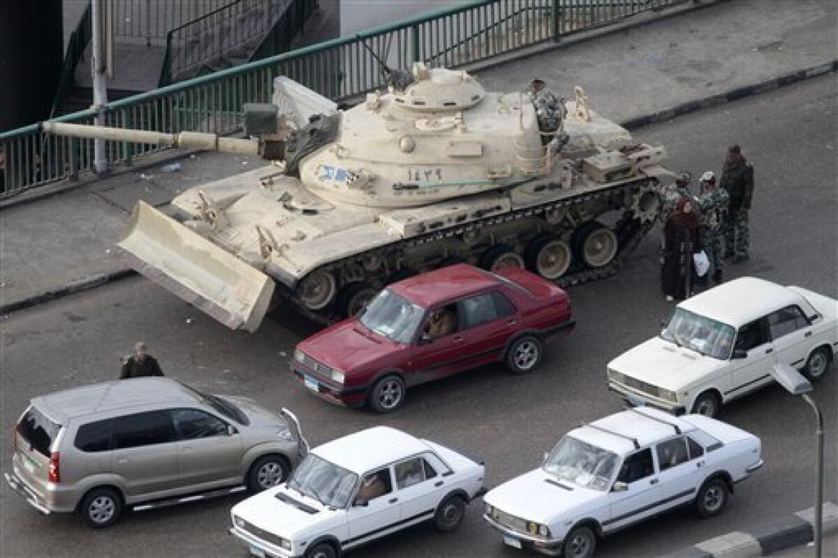 A tank is parked near Tahrir, or Liberation, Square in Cairo, Egypt, Tuesday, Feb 1, 2011. Security officials say authorities have shut down all roads and public transportation to Cairo, where tens of thousands of people are converging to demand the ouster of Egyptian President Hosni Mubarak after nearly 30 years in power. (AP Photo/Lefteris Pitarakis)