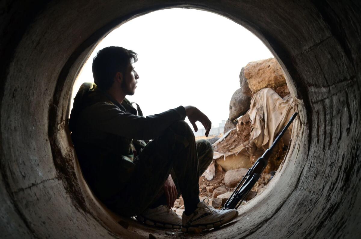 A rebel fighter rests during clashes with pro-government forces in the Syrian province of Homs in October.