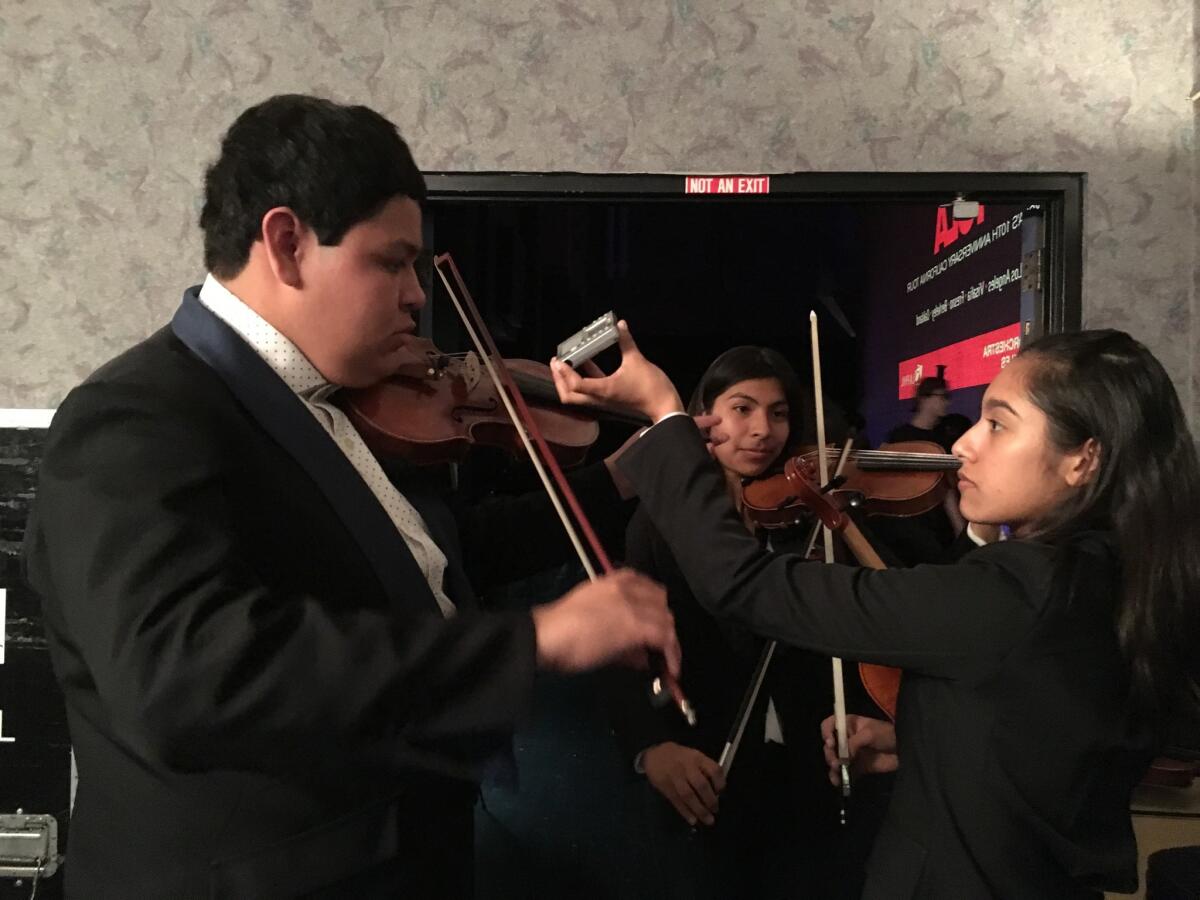 Our concertmaster, Beatrice Padilla, makes sure Jacob Molina and the rest of us are in tune for our concert.