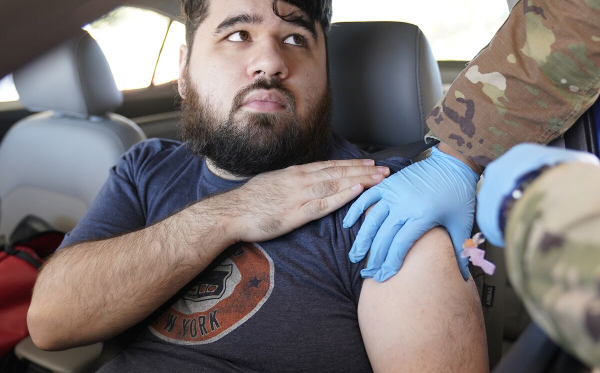 Social worker Jonathan De La Rosa gets a Pfizer COVID-19 vaccine booster shot in Mesquite, Texas.