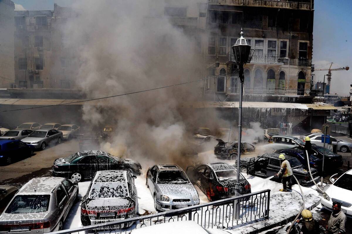 A photo provided by Syria's state-run news agency shows the aftermath of a bombing at a judicial complex in Damascus.