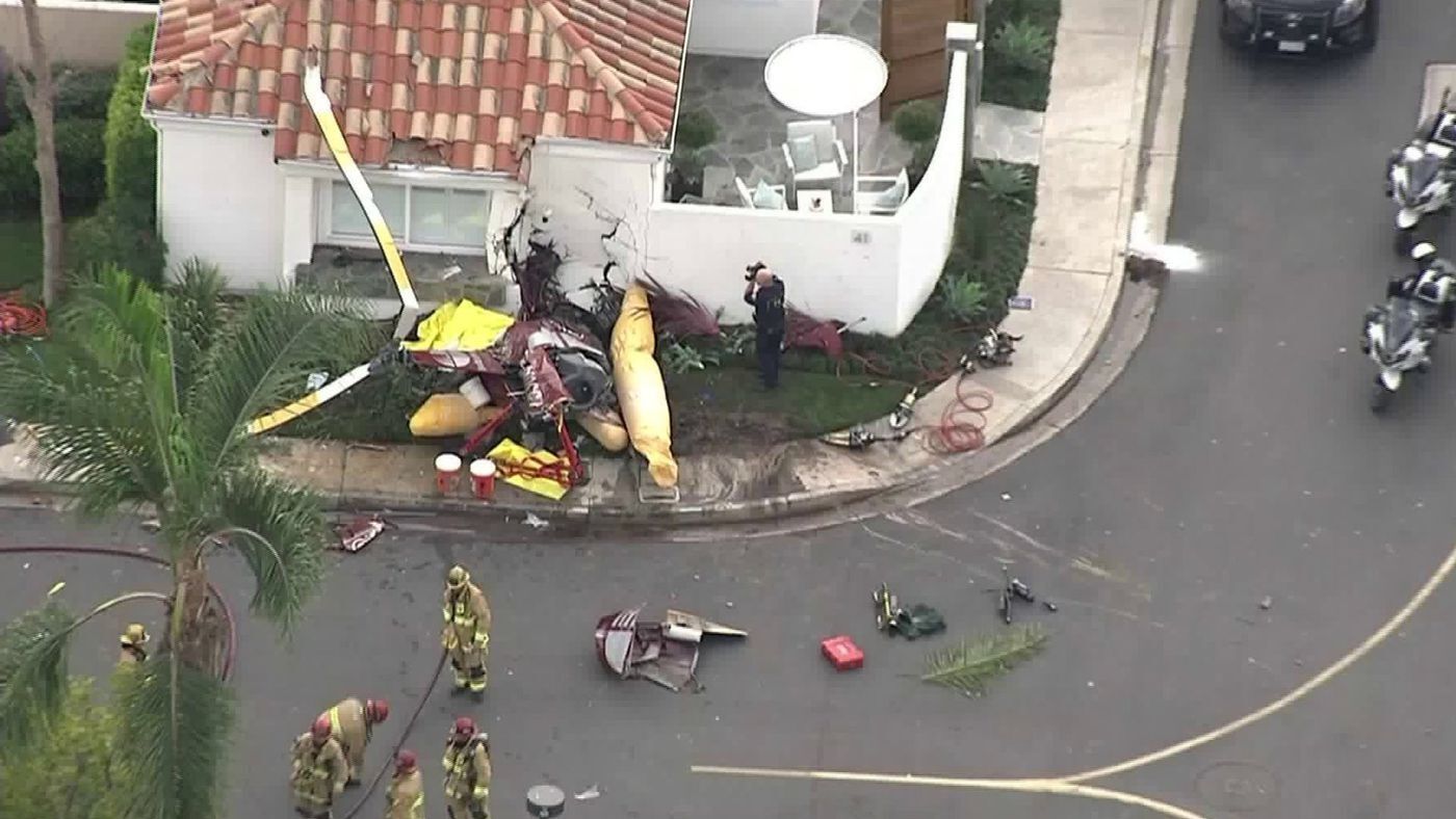 Wreckage fills the scene where a helicopter crashed into a Newport Beach house in a gated community Tuesday afternoon.