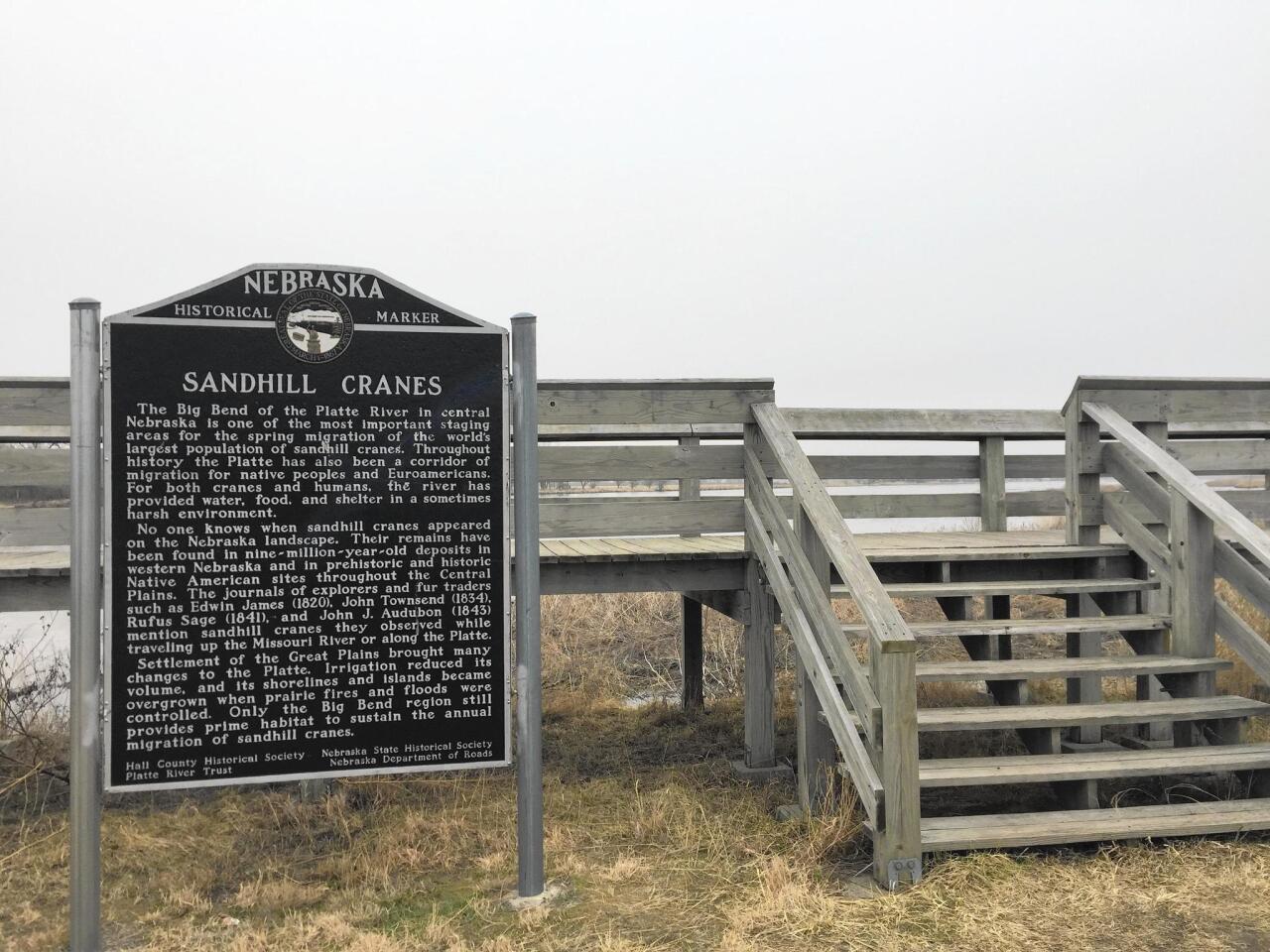 A historical marker at a viewing platform in central Nebraska tells the story of the sandhill crane migration, which brings hundreds of thousands of birds to the region each year between late February and early April.