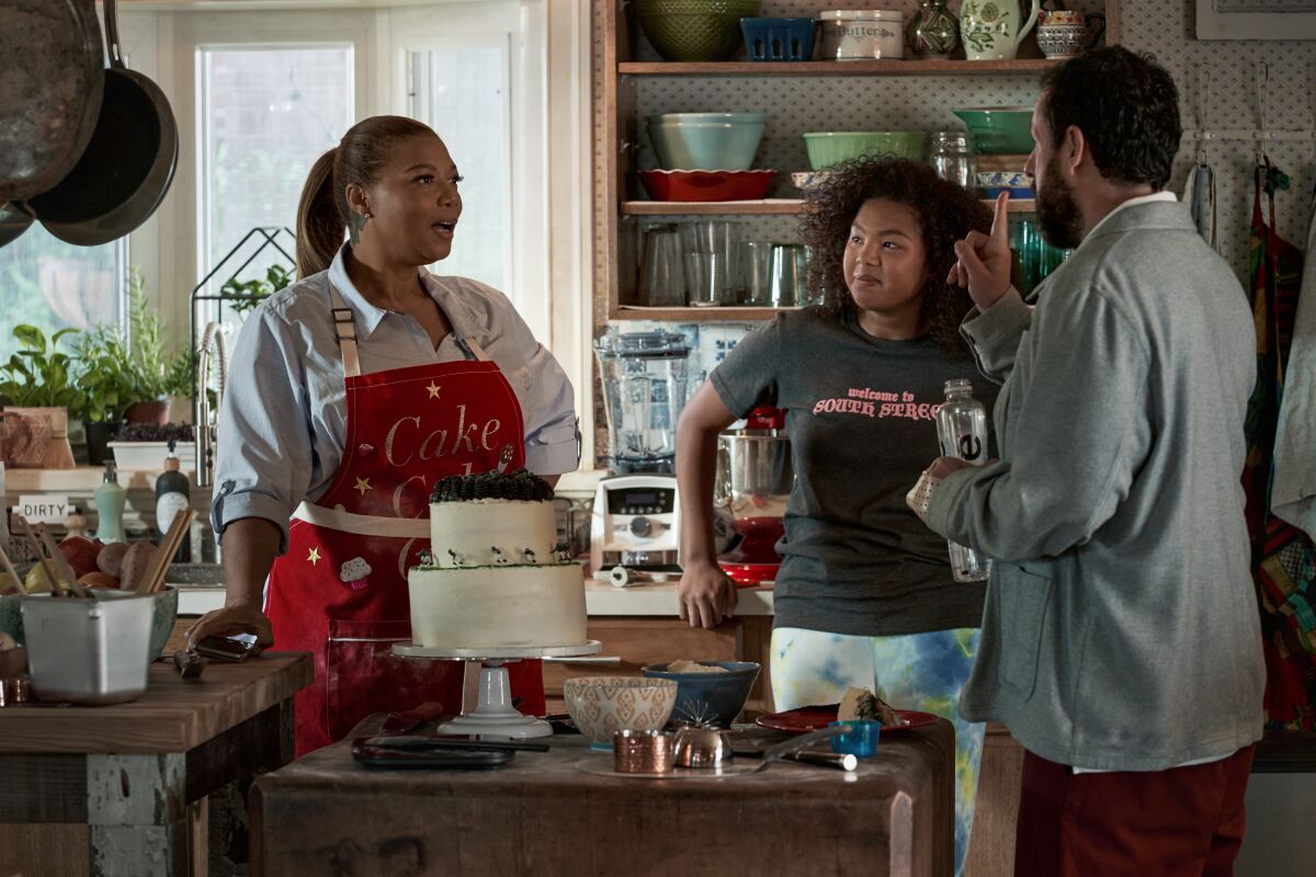 A kitchen scene with Queen Latifah as mother, Jordan Hull as daughter and Adam Sandler as father.