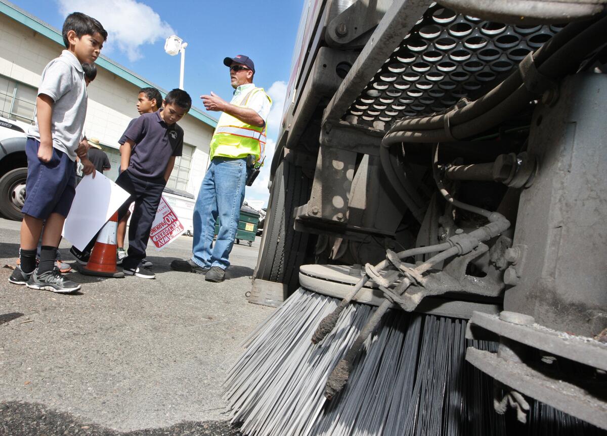 Students from St. Finbar Parish School take a close look at a street sweeper during a visit to the Burbank Public Works Department on Tuesday, May 20, 2014 as part of Burbank's Public Works Week.