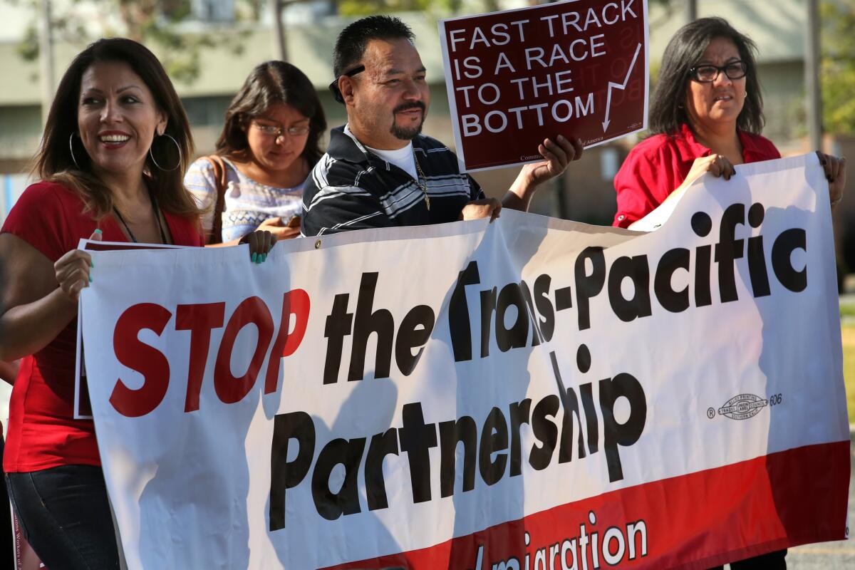 Workers from the AT&T call center and others rally against the proposed Trans-Pacific Partnership trade pact in City of Commerce.