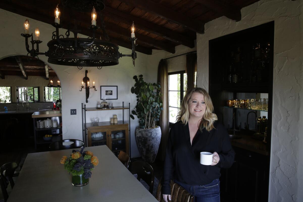 Designer Deirdre Doherty stands in the dining area of the home she updated.