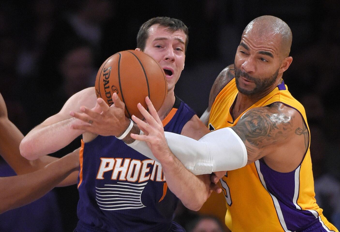 Carlos Boozer and Suns guard Goran Dragic battle for a loose ball during the first half of a game on Nov. 4.