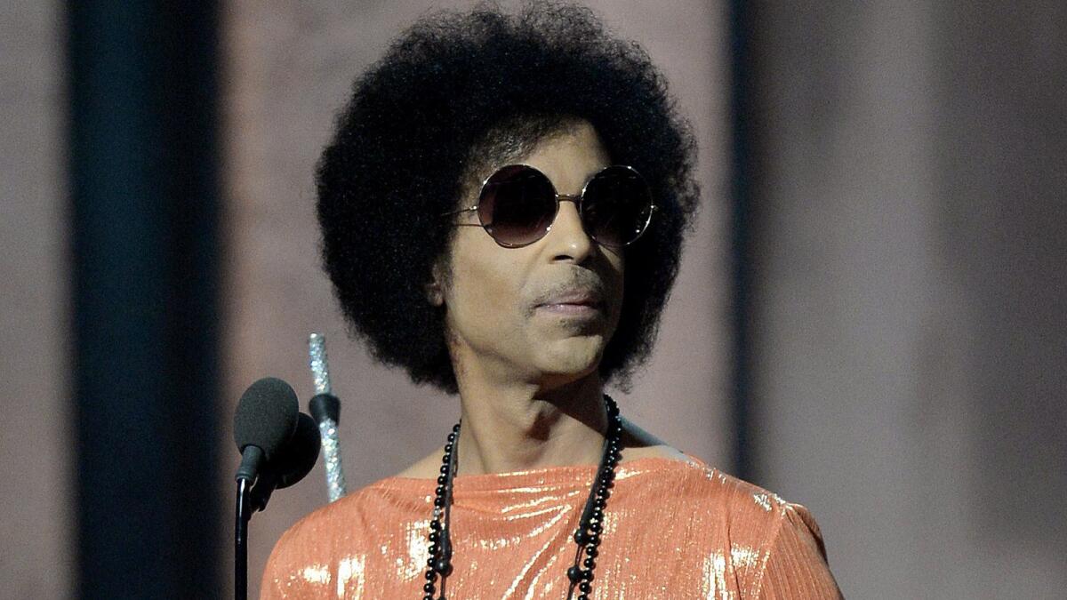 Prince presents an award at the 57th Annual Grammy Awards in Los Angeles.