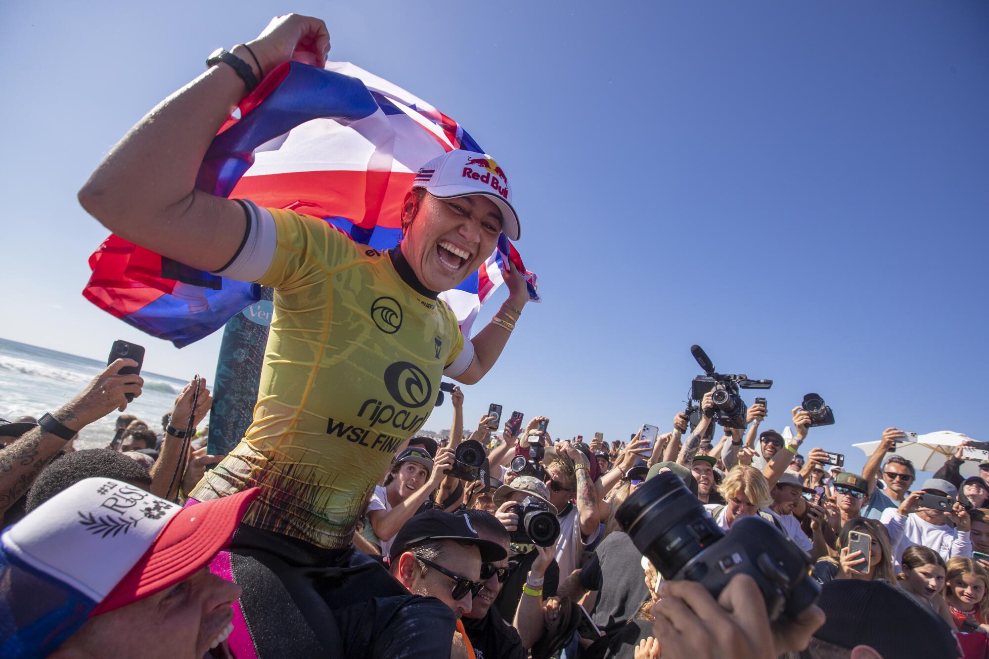 Carissa Moore is carried up the beach after winning the title