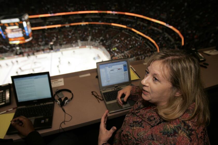 Los Angeles Times hockey writer and columnist, Helene Elliott, in the press box high.