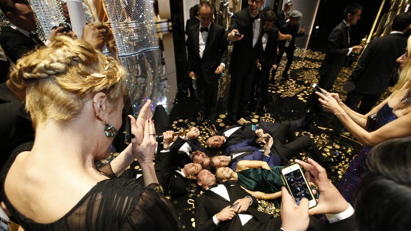 The cast of Best Picture winner "Spotlight" takes a selfie backstage at the 88th Academy Awards at the Dolby Theatre.