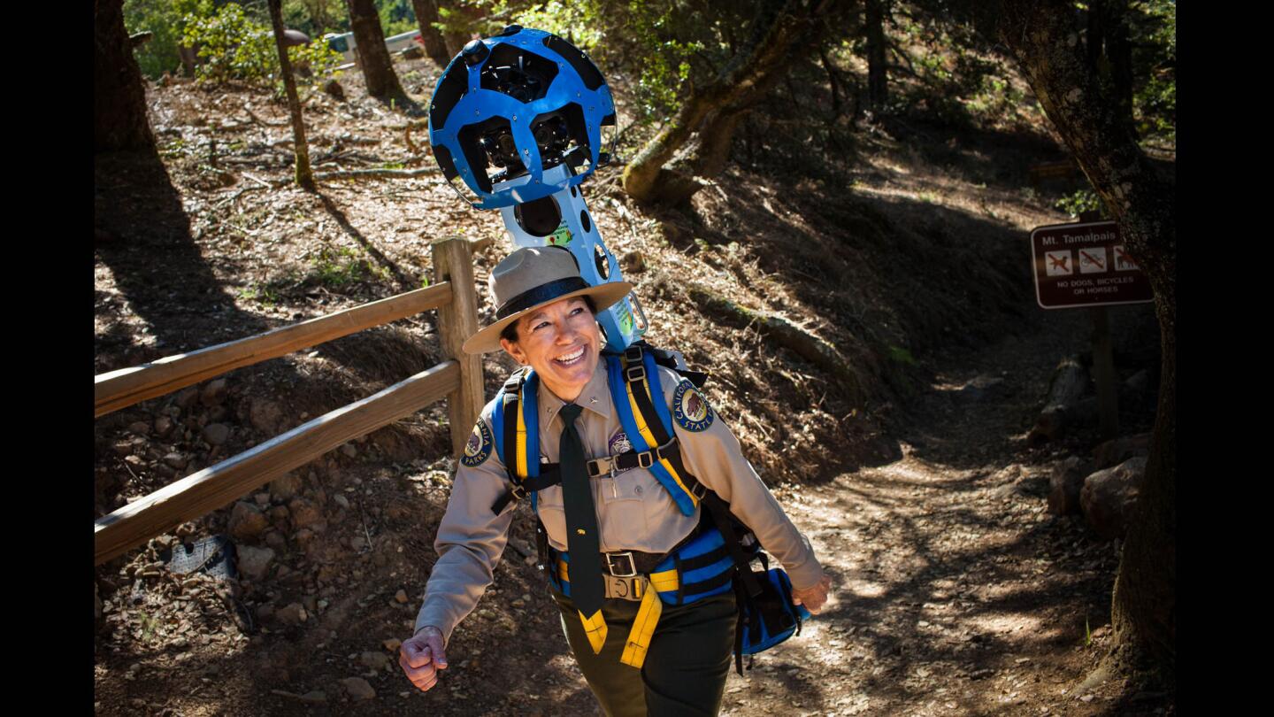 State park ranger Danita Rodriguez tries out the Google Trekker backpack during a news conference Tuesday Mt. Tamalpais State Park in Marin County. The state Department of Parks and Recreation has teamed with Google to map hiking trails with the 15-lens camera. The 360-degree views are available on Google Street View.