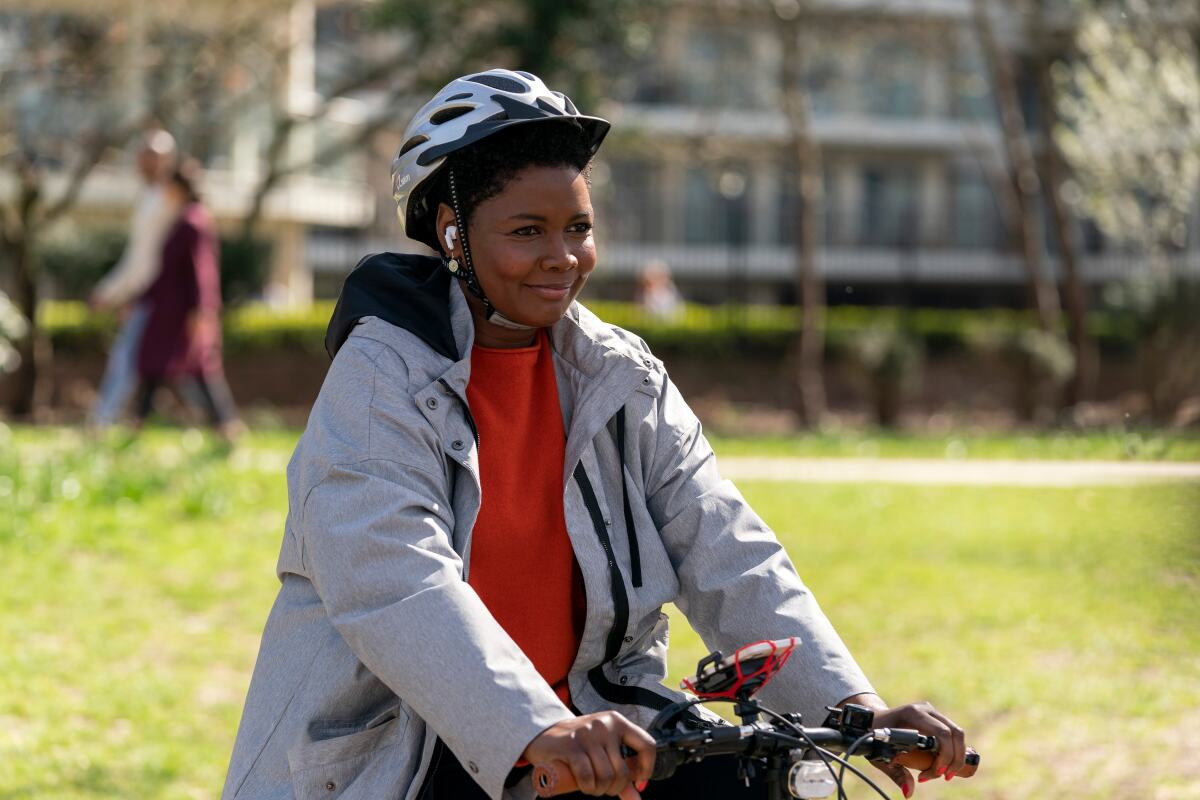 A woman rides a bike.