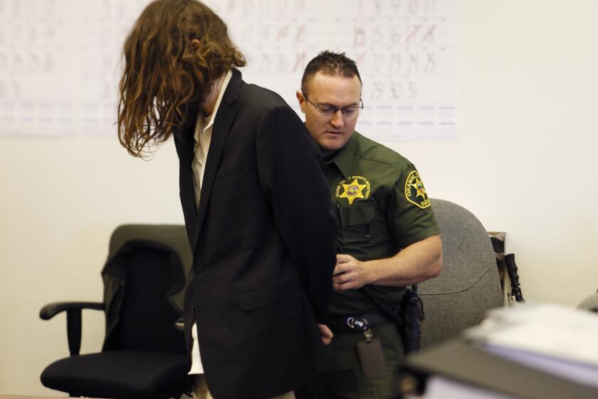 Samuel Woodward is escorted into Dept. 30 at the Central Justice Center in Santa Ana.