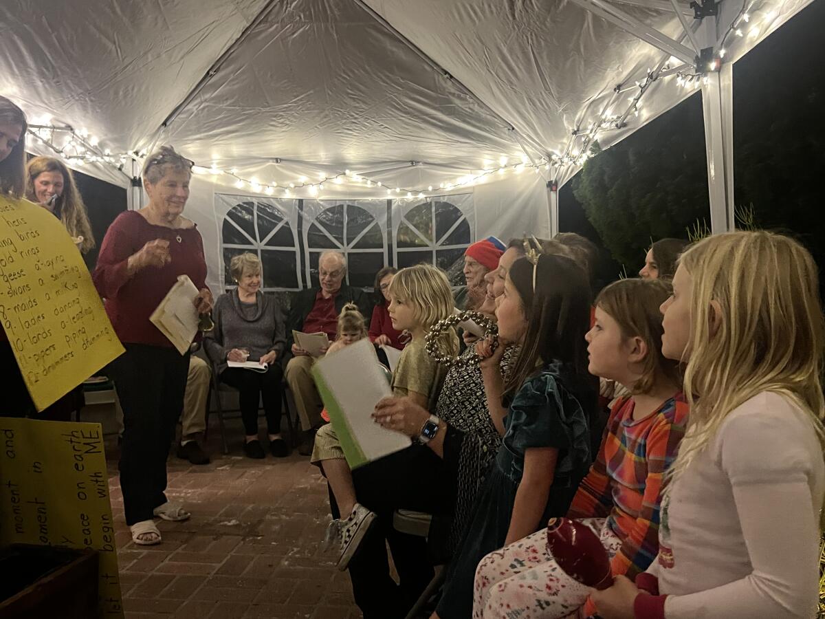 Martha O'Meara, left, instructs children at this year's Christmas party at her Costa Mesa home. 