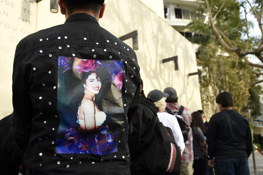 Fans of the late singer Selena Quintanilla wait in line to attend a ceremony to award her a posthumous star on the Hollywood Walk of Fame on Friday, Nov. 3, 2017, in Los Angeles. (Photo by Chris Pizzello/Invision/AP)