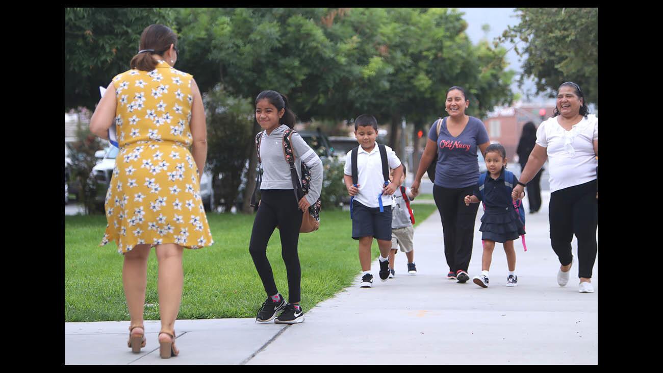 Cerritos Elementary School principal Perla Chavez-Fritz, left, greets fourth grader Melissa Argumedo on the first day of the classes at the Glendale school on Wednesday, Aug. 22, 2018.