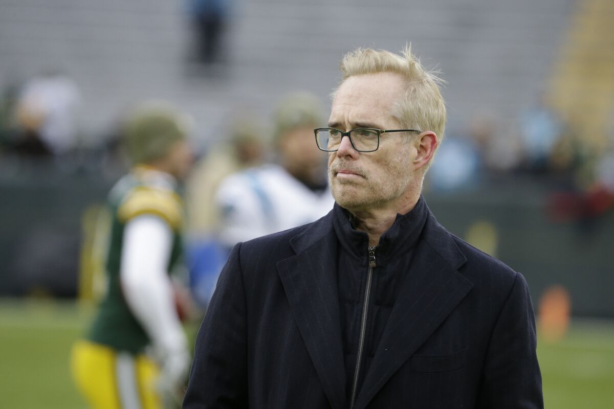 Joe Buck se tient sur un terrain de football avant un match des Packers de Green Bay.