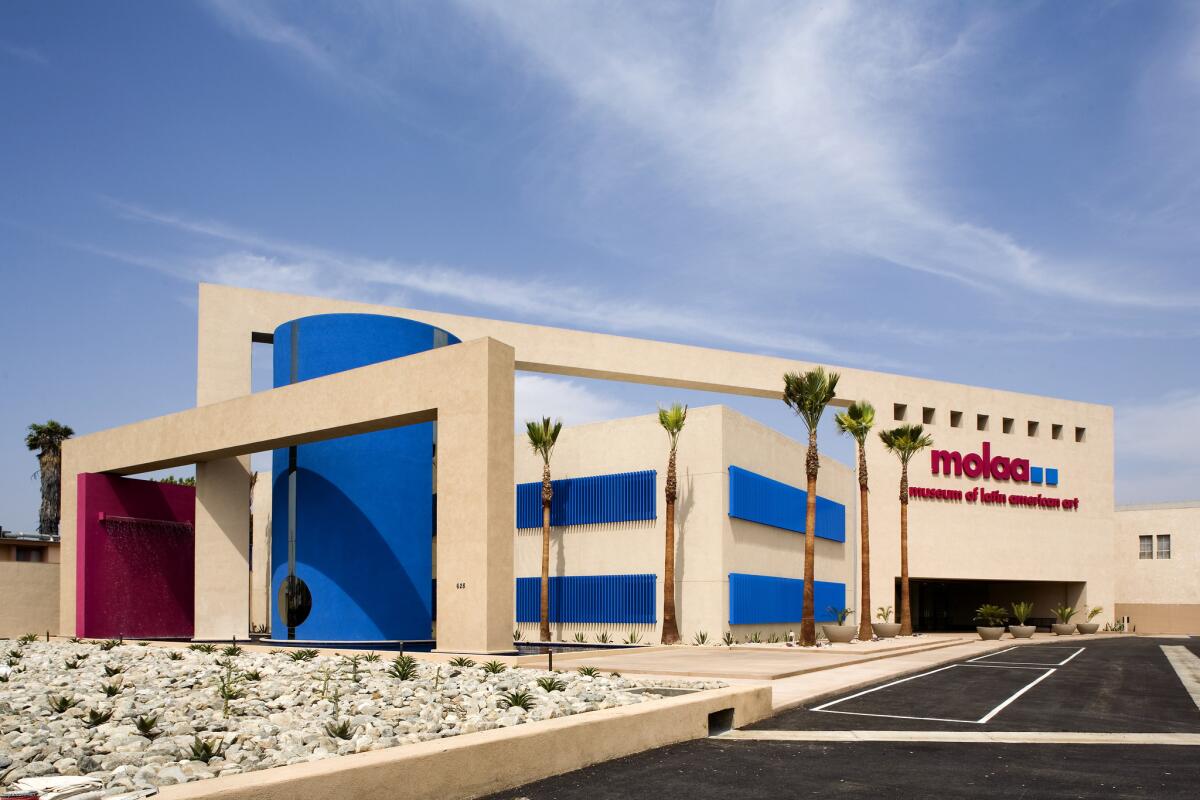 A wide view of MOLAA's Postmodern facade, in shade of white, blue and pink.