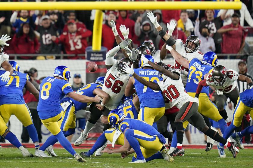 Los Angeles Rams' Matt Gay (8) kicks a game-winning field goal against the Tampa Bay Buccaneers during the second half of an NFL divisional round playoff football game Sunday, Jan. 23, 2022, in Tampa, Fla. (AP Photo/John Raoux)