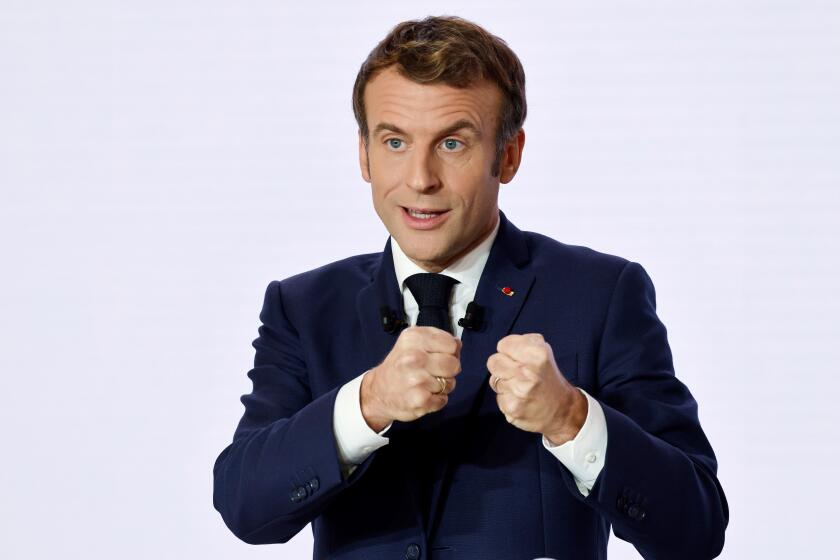 FILE - French President Emmanuel Macron gestures as he delivers a speech during a press conference on France assuming EU presidency, Thursday, Dec. 9, 2021 in Paris. President Emmanuel Macron has provoked outcries in parliament and shrill protests from election rivals by using a vulgarity to describe his strategy for pressuring vaccine refusers to get coronavirus jabs. (Ludovic Marin/Pool Photo via AP, File)