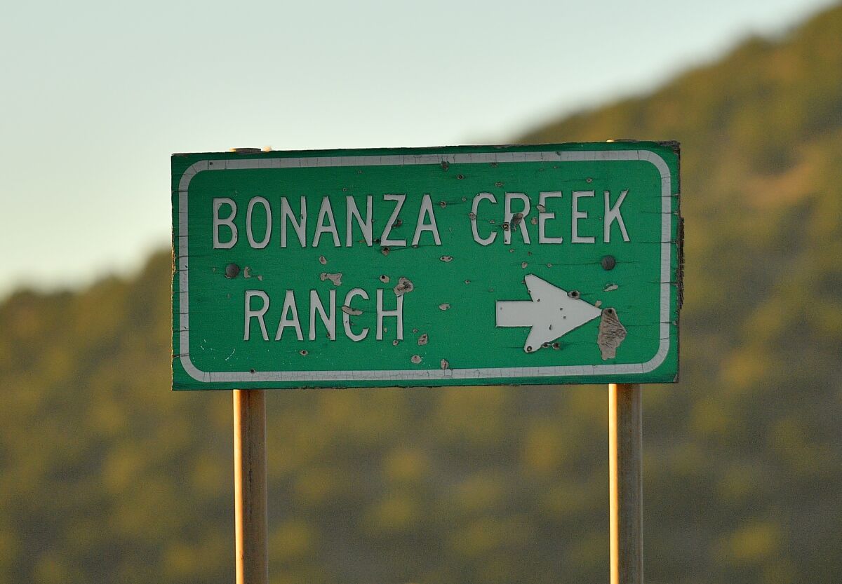 A sign points in the direction of Bonanza Creek Ranch near Santa Fe, New Mexico. 