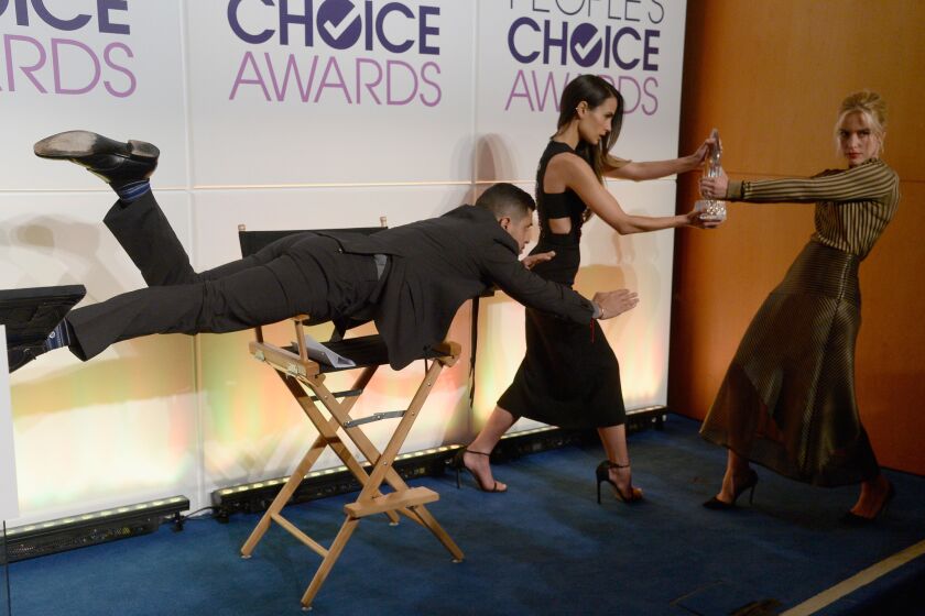 Wilmer Valderrama, Jordana Brewster and Piper Perabo hold the People's Choice Award during the mannequin challenge a news conference in Beverly Hills